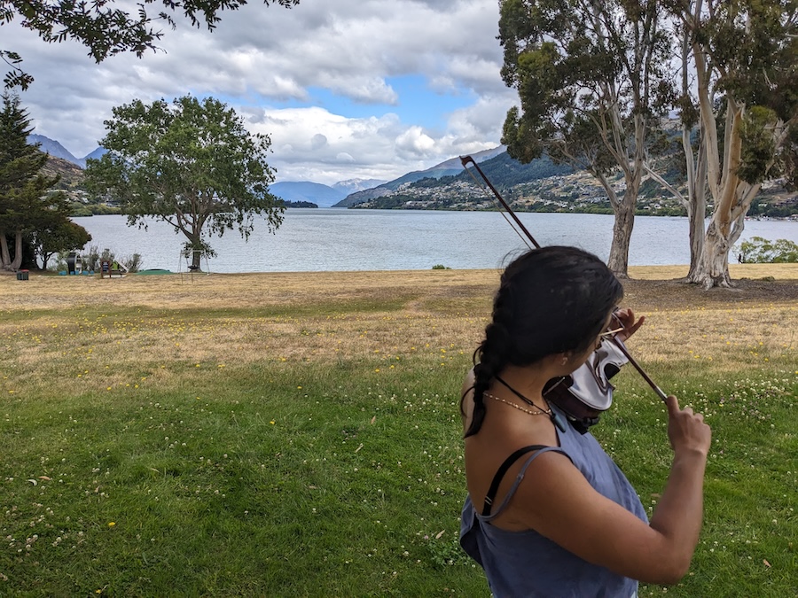 Shanti playing viola by Queenstown lake